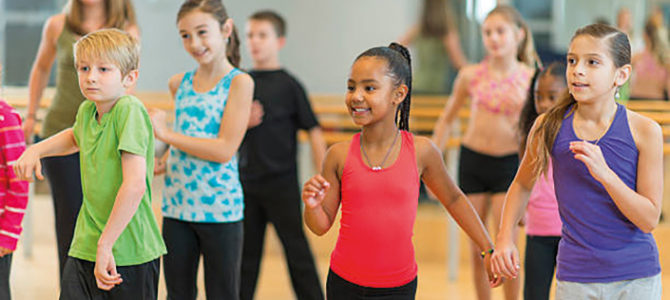 Diverse group of children taking a dance fitness class