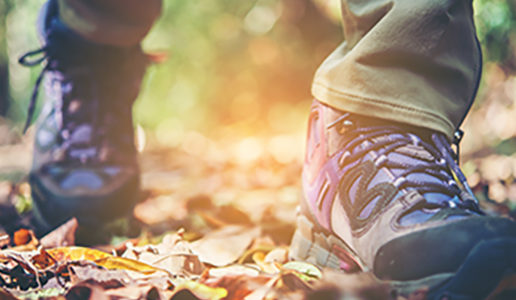 Close up of adventure woman feet walk on a mountain path.